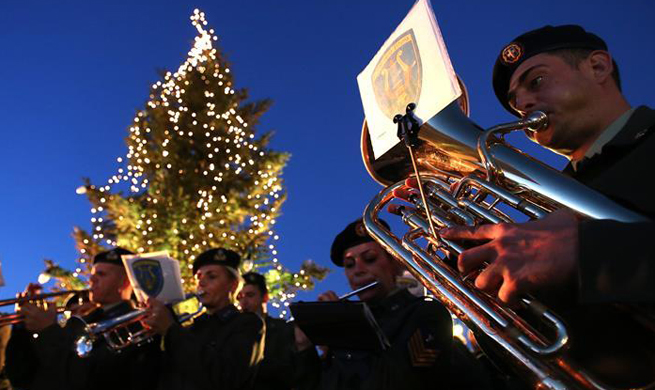 Fire-ravaged Greek seaside resort lights Xmas tree, sending message of hope, determination