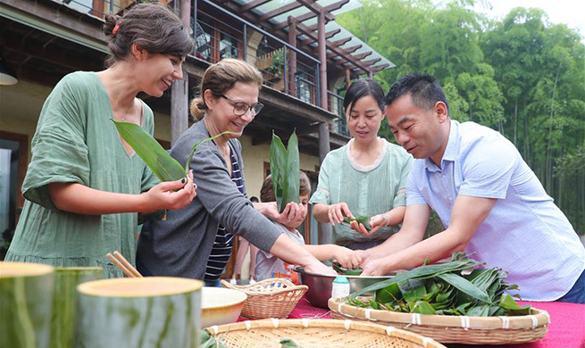 Various events held across China to celebrate upcoming Dragon Boat Festival